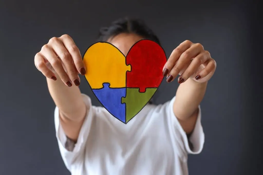 colorful-puzzle-heart-shape-covering-face-young-girl-world-autism-awareness-day-1024x683